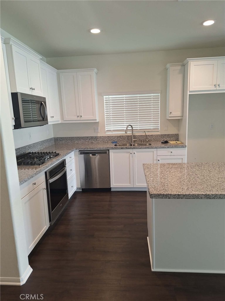 35170 Webb Place Beaumont, CA 92223 - Photo 2 of 21 a kitchen with granite countertop a sink cabinets and stainless steel appliances