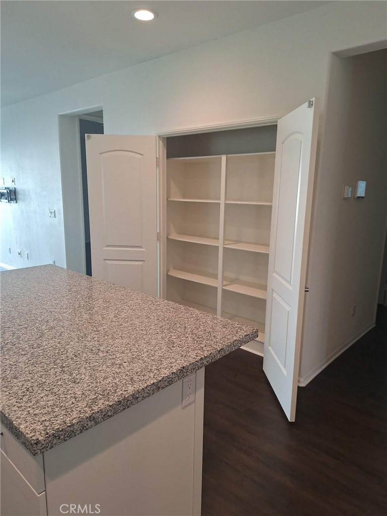 35170 Webb Place Beaumont, CA 92223 - Photo 4 of 21 a view of cabinets and wooden floor