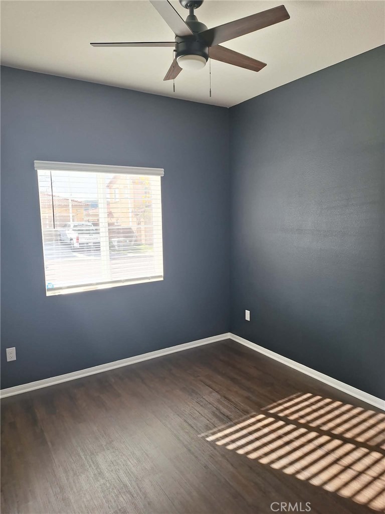 35170 Webb Place Beaumont, CA 92223 - Photo 10 of 21 an empty room with wooden floor and windows