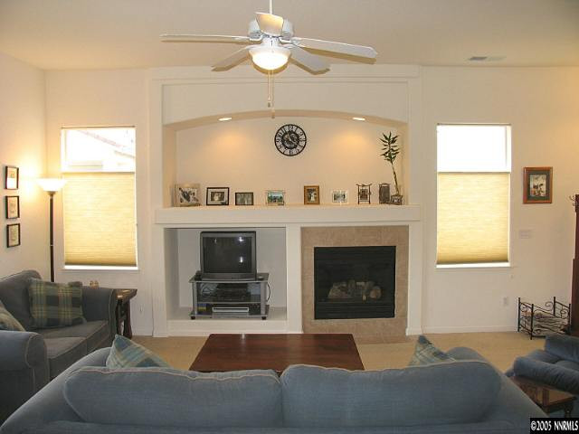2595 Perryville Drive Reno, NV 89521 - Photo 4 of 9 a living room with furniture a window and a fireplace