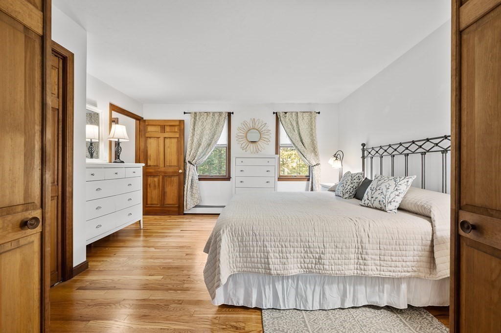 152 Warren Road Brimfield, MA 01010 - Photo 11 of 33 a bedroom with a large bed and a dresser