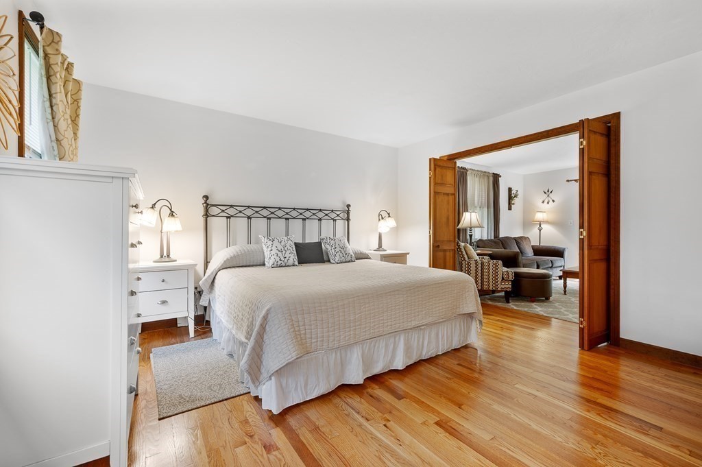 152 Warren Road Brimfield, MA 01010 - Photo 12 of 33 a bedroom with a bed and wooden floor