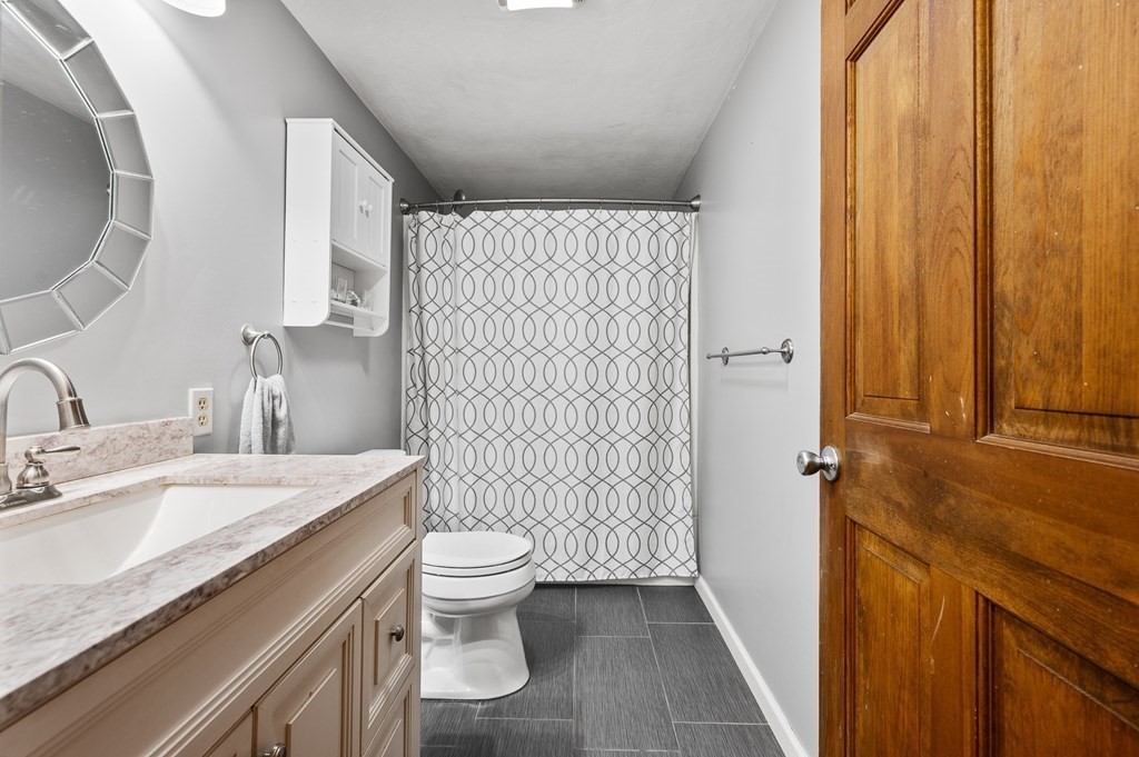 152 Warren Road Brimfield, MA 01010 - Photo 19 of 33 a bathroom with a granite countertop sink toilet and shower