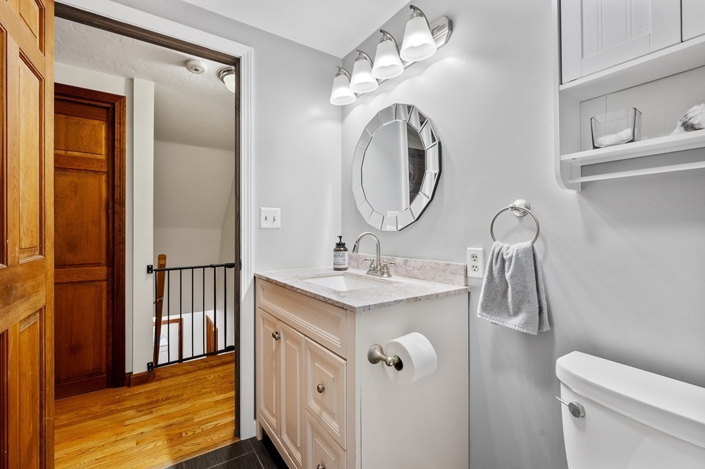 152 Warren Road Brimfield, MA 01010 - Photo 20 of 33 a bathroom with a granite countertop sink a toilet and a mirror