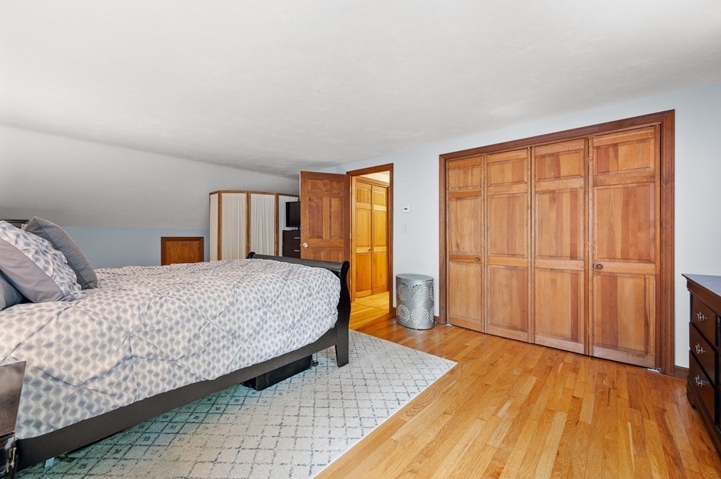 152 Warren Road Brimfield, MA 01010 - Photo 23 of 33 a bedroom with a large bed and wooden floor