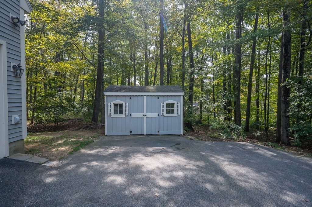 152 Warren Road Brimfield, MA 01010 - Photo 30 of 33 a view of a barn in the middle of a forest