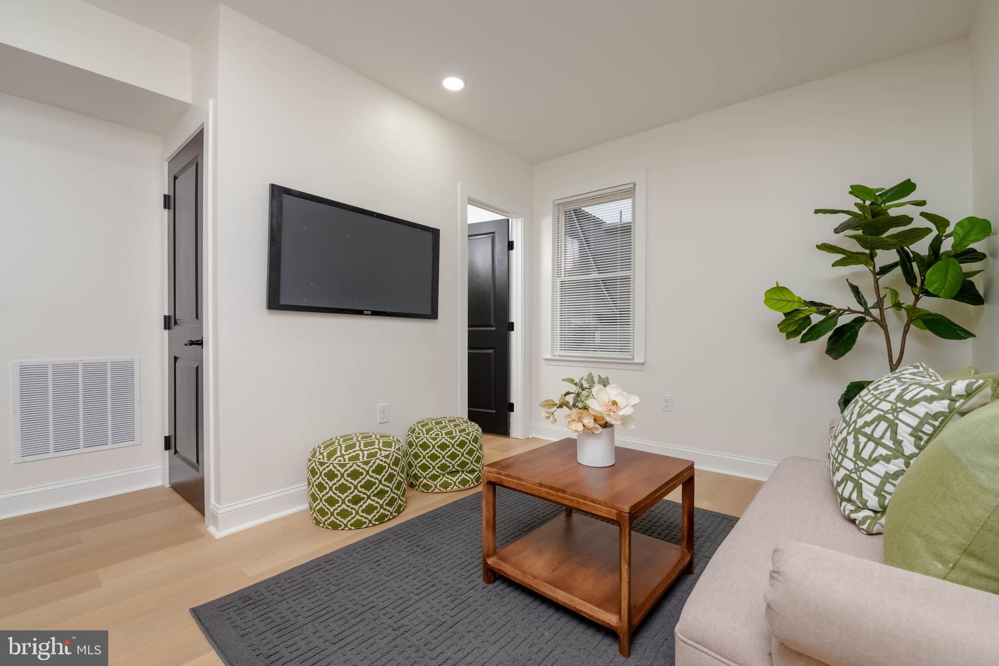 1117 Overbrook Road Baltimore, MD 21239 - Photo 11 of 37 a living room with furniture and a flat screen tv