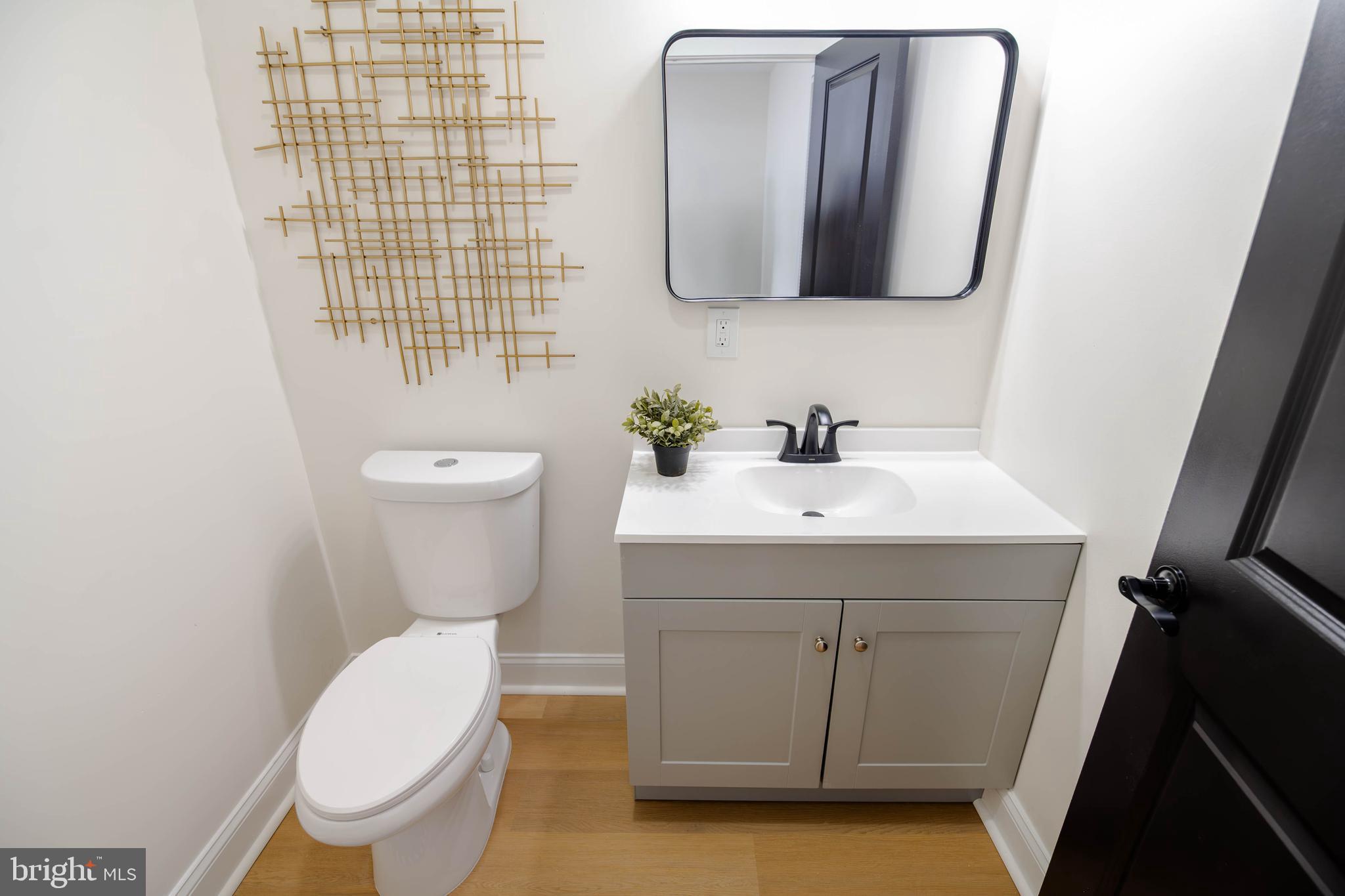 1117 Overbrook Road Baltimore, MD 21239 - Photo 14 of 37 a bathroom with a toilet sink and mirror