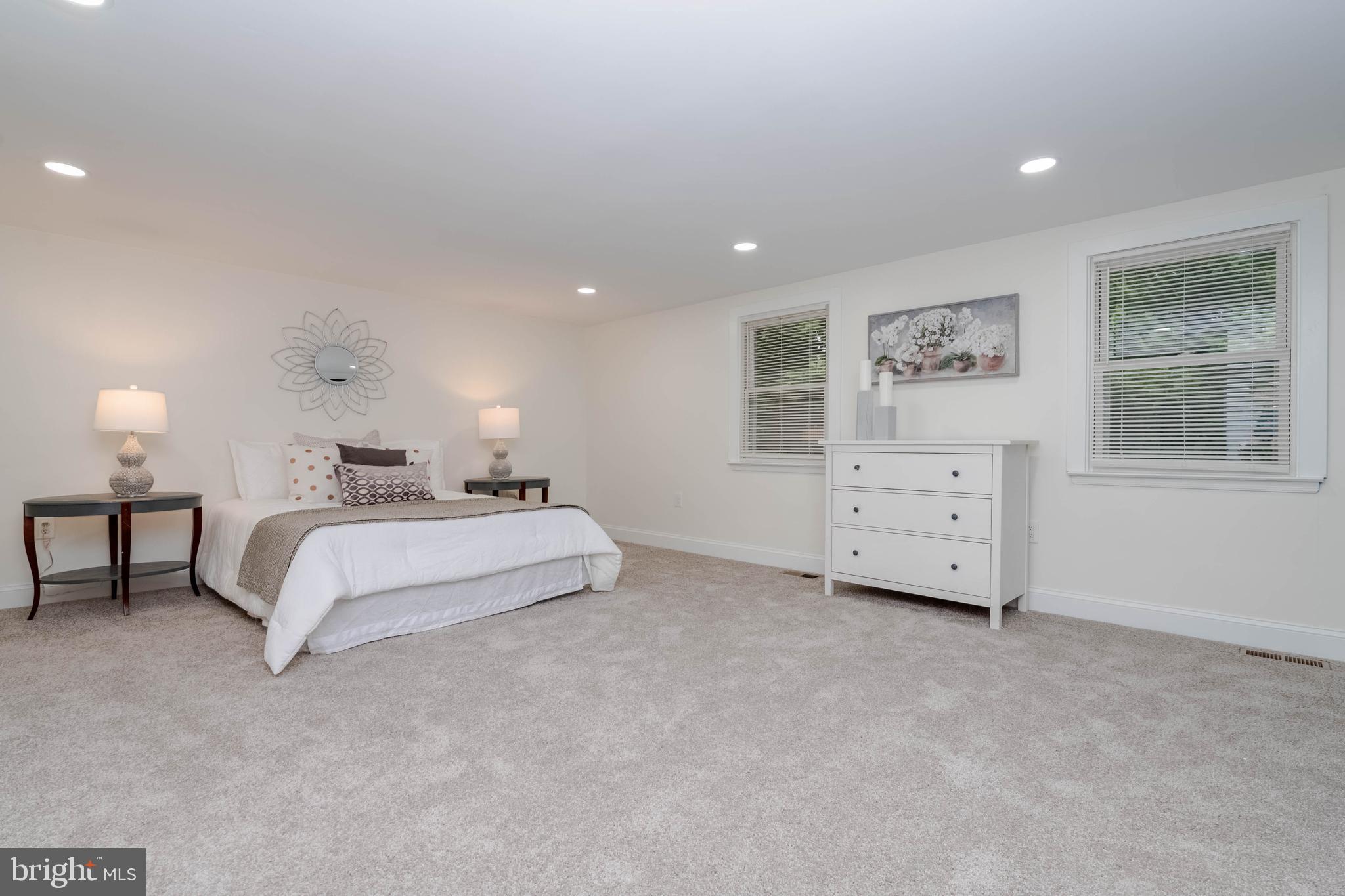 1117 Overbrook Road Baltimore, MD 21239 - Photo 15 of 37 a spacious bedroom with a bed and a night stand