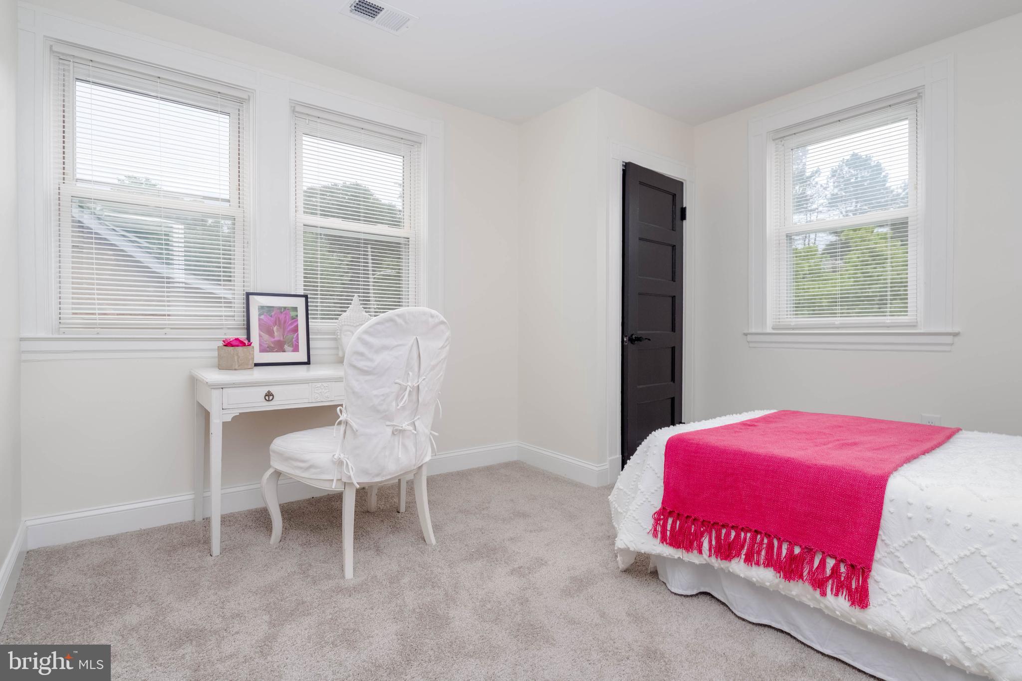 1117 Overbrook Road Baltimore, MD 21239 - Photo 18 of 37 a bedroom with a bed and a chair