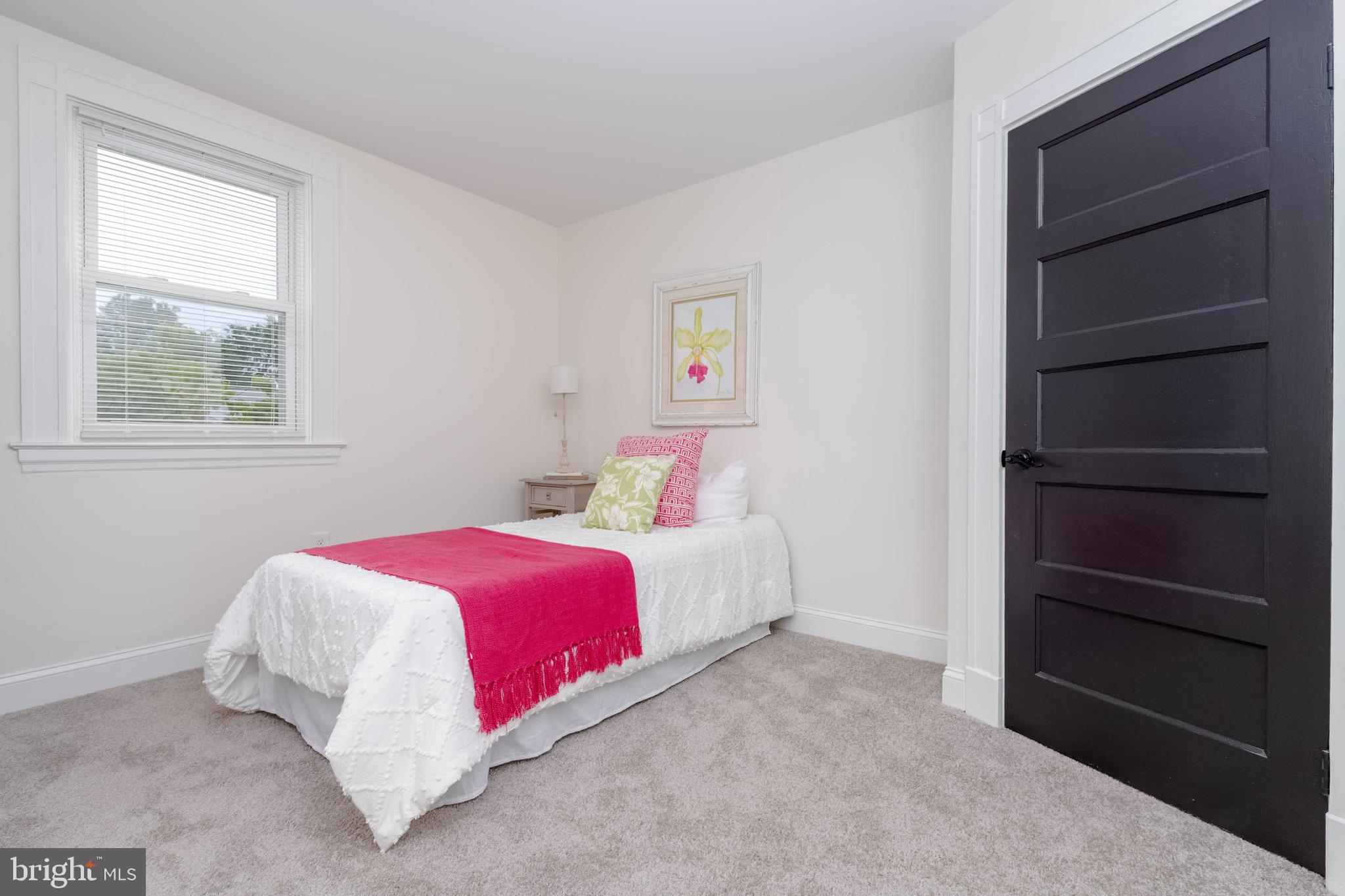 1117 Overbrook Road Baltimore, MD 21239 - Photo 19 of 37 a bedroom with a bed and a window