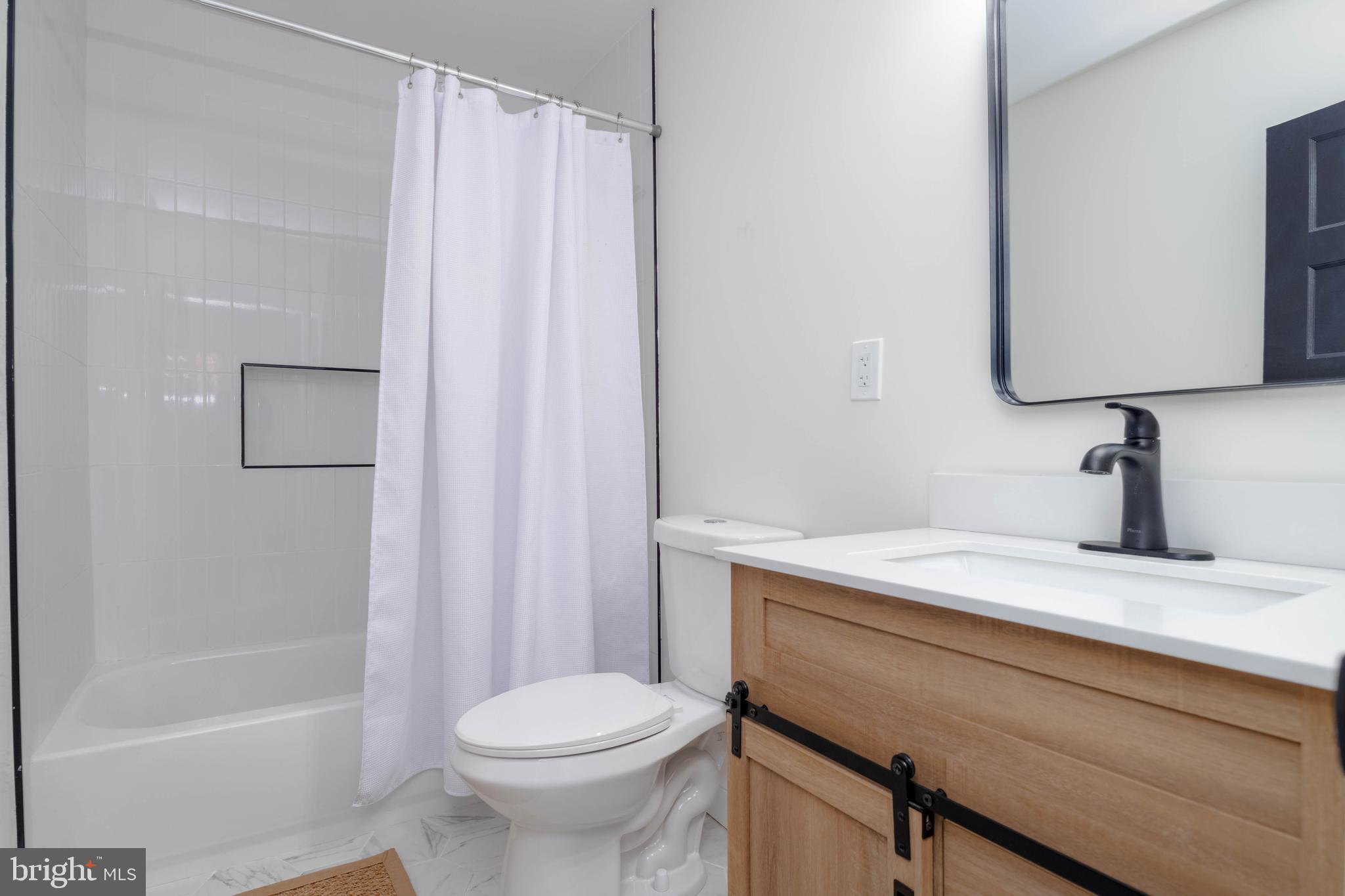 1117 Overbrook Road Baltimore, MD 21239 - Photo 20 of 37 a bathroom with a sink a toilet and shower