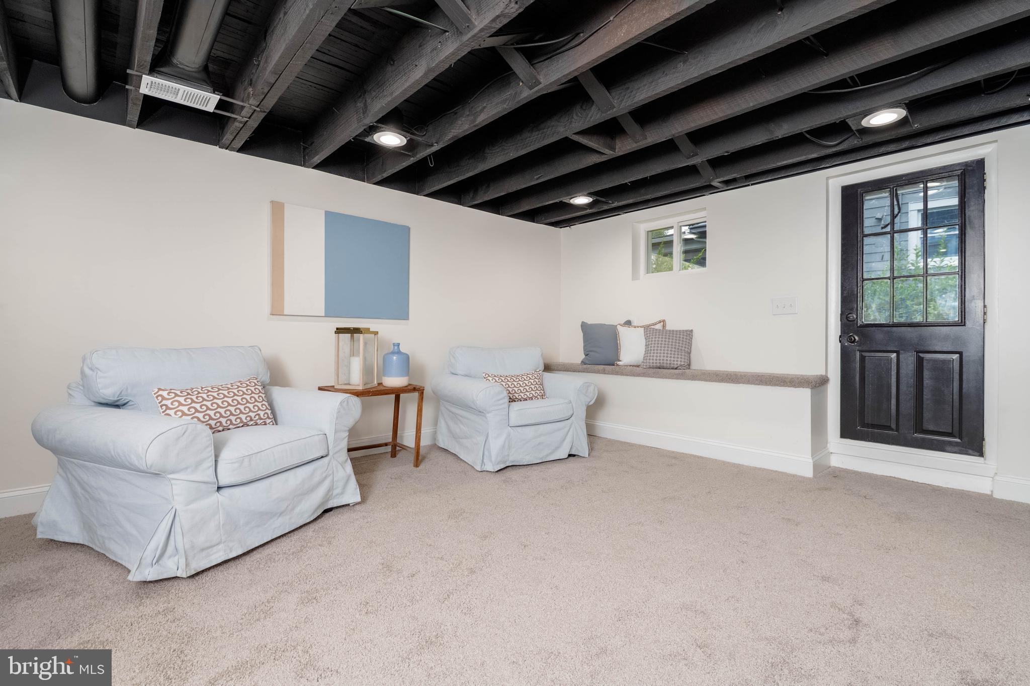 1117 Overbrook Road Baltimore, MD 21239 - Photo 23 of 37 a living room with furniture and a chandelier