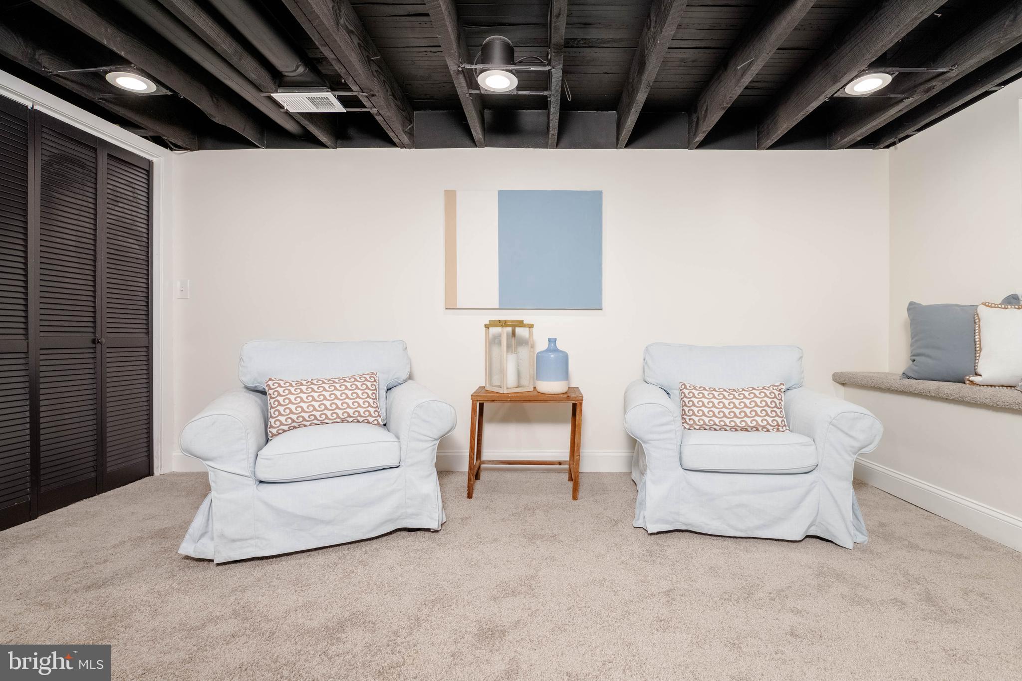 1117 Overbrook Road Baltimore, MD 21239 - Photo 24 of 37 a living room with furniture and a walk in closet