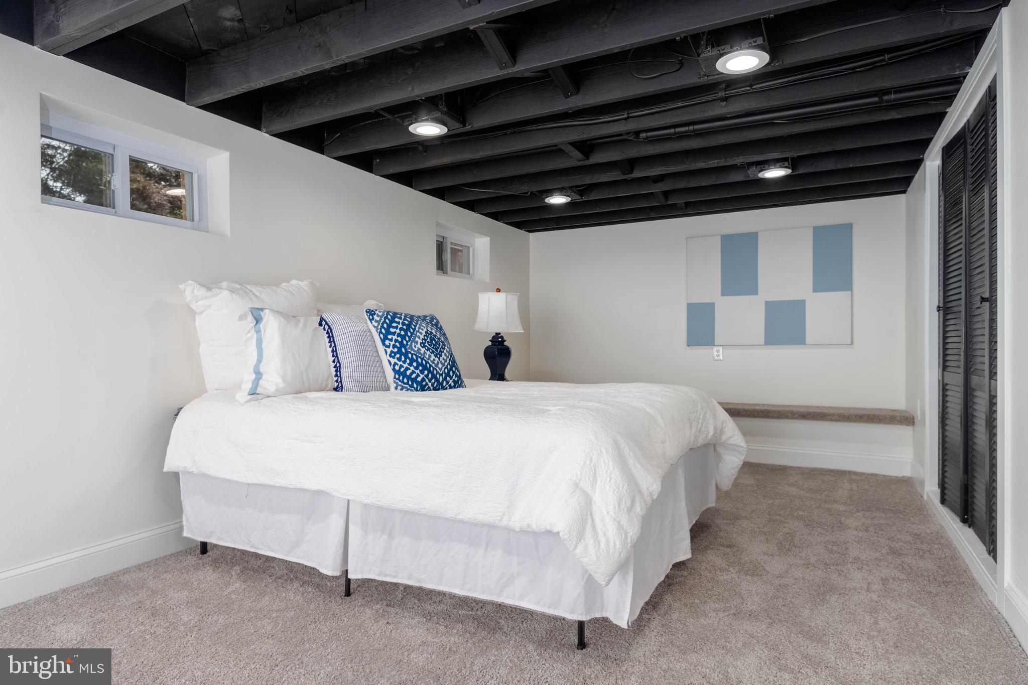 1117 Overbrook Road Baltimore, MD 21239 - Photo 30 of 37 a large bed sitting in a bedroom next to a window