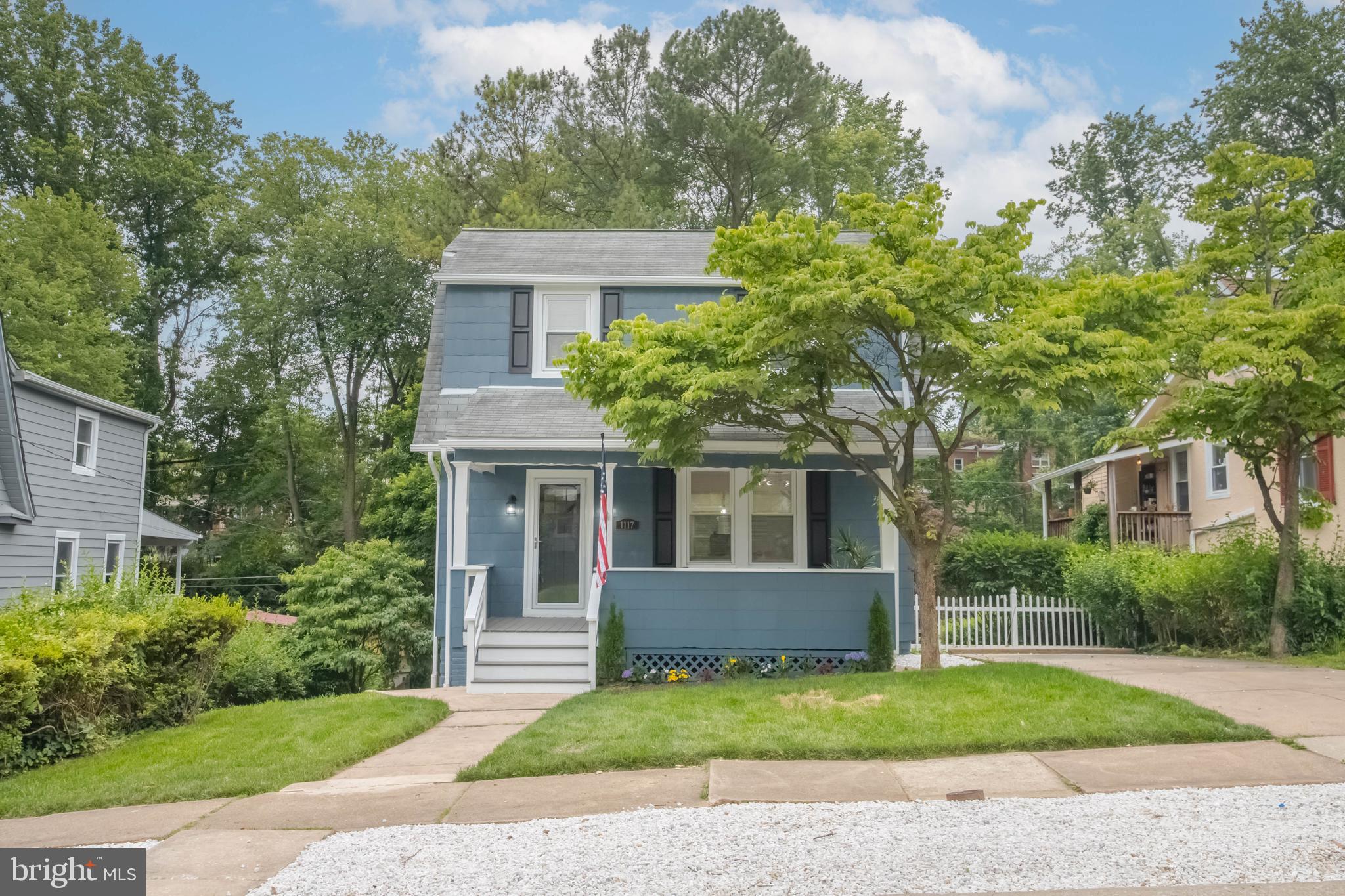 1117 Overbrook Road Baltimore, MD 21239 - Photo 3 of 37 a front view of a house with a yard and trees