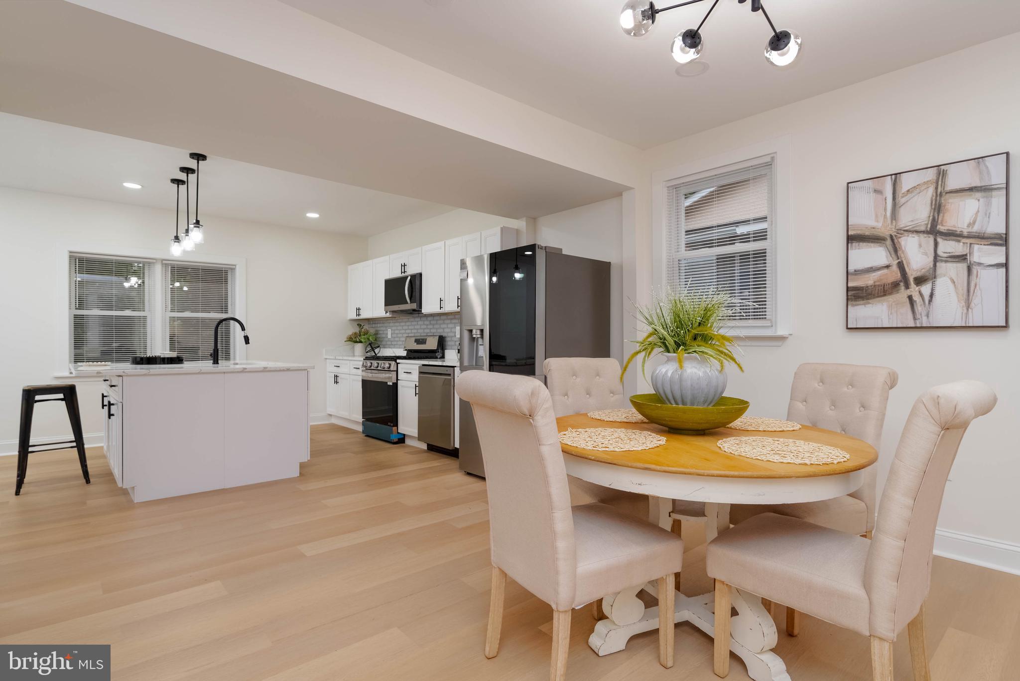 1117 Overbrook Road Baltimore, MD 21239 - Photo 8 of 37 a kitchen with a table and chairs in it