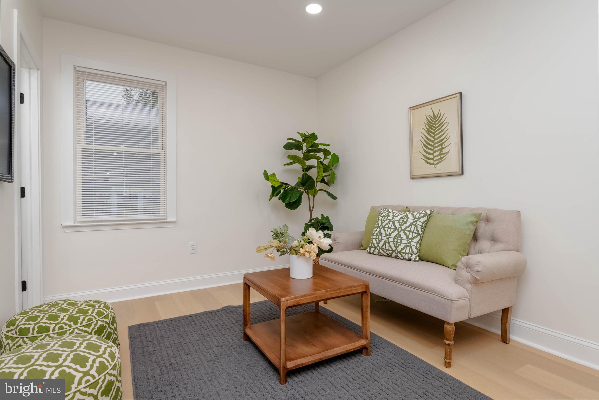 1117 Overbrook Road Baltimore, MD 21239 - Photo 10 of 37 a living room with furniture and a potted plant