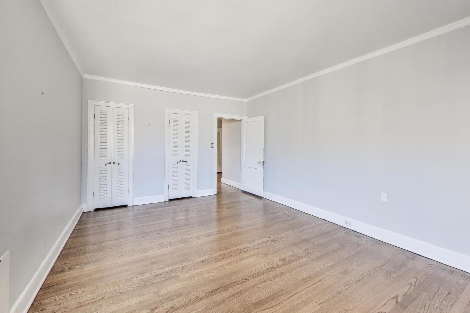 1755 East 55th Street, Unit 1204 Chicago, IL 60615 - Photo 11 of 19 a view of an empty room with wooden floor