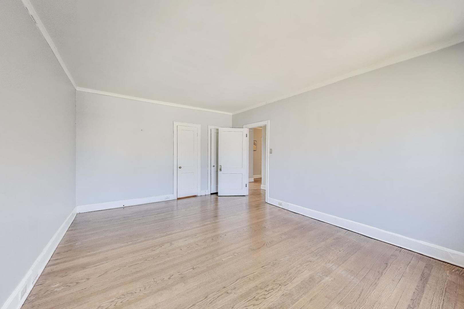 1755 East 55th Street, Unit 1204 Chicago, IL 60615 - Photo 14 of 19 a view of an empty room with wooden floor