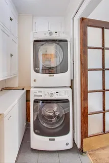 a utility room with washing machine and a washing machine