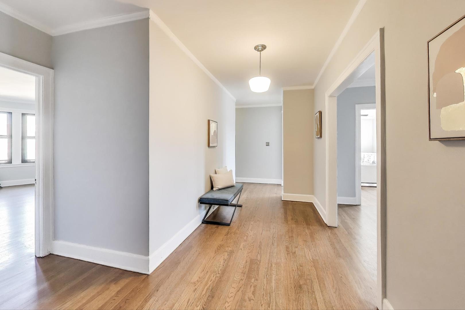 1755 East 55th Street, Unit 1204 Chicago, IL 60615 - Photo 3 of 19 wooden floor in an empty room with a window
