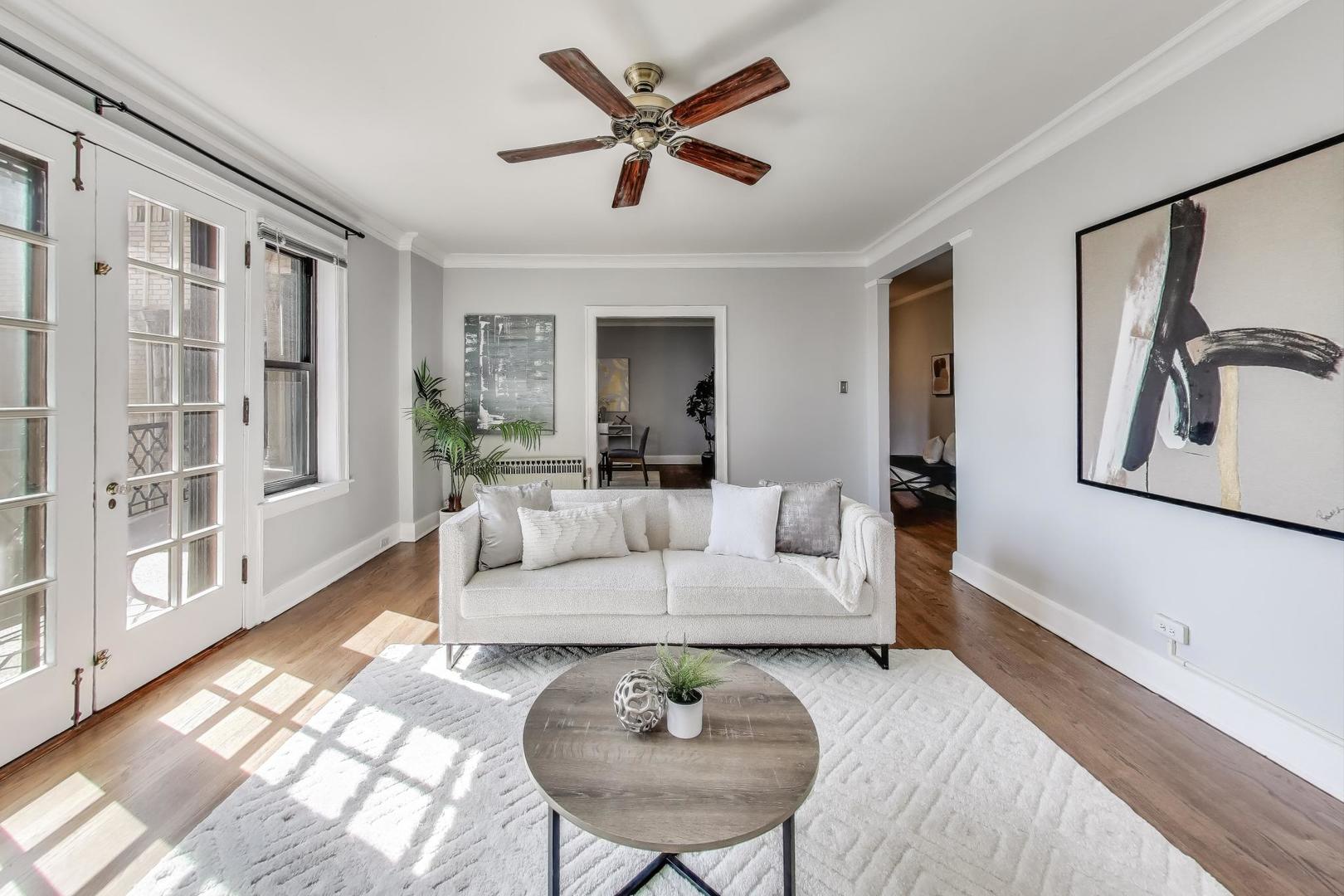 1755 East 55th Street, Unit 1204 Chicago, IL 60615 - Photo 5 of 19 a living room with furniture a table and a large window