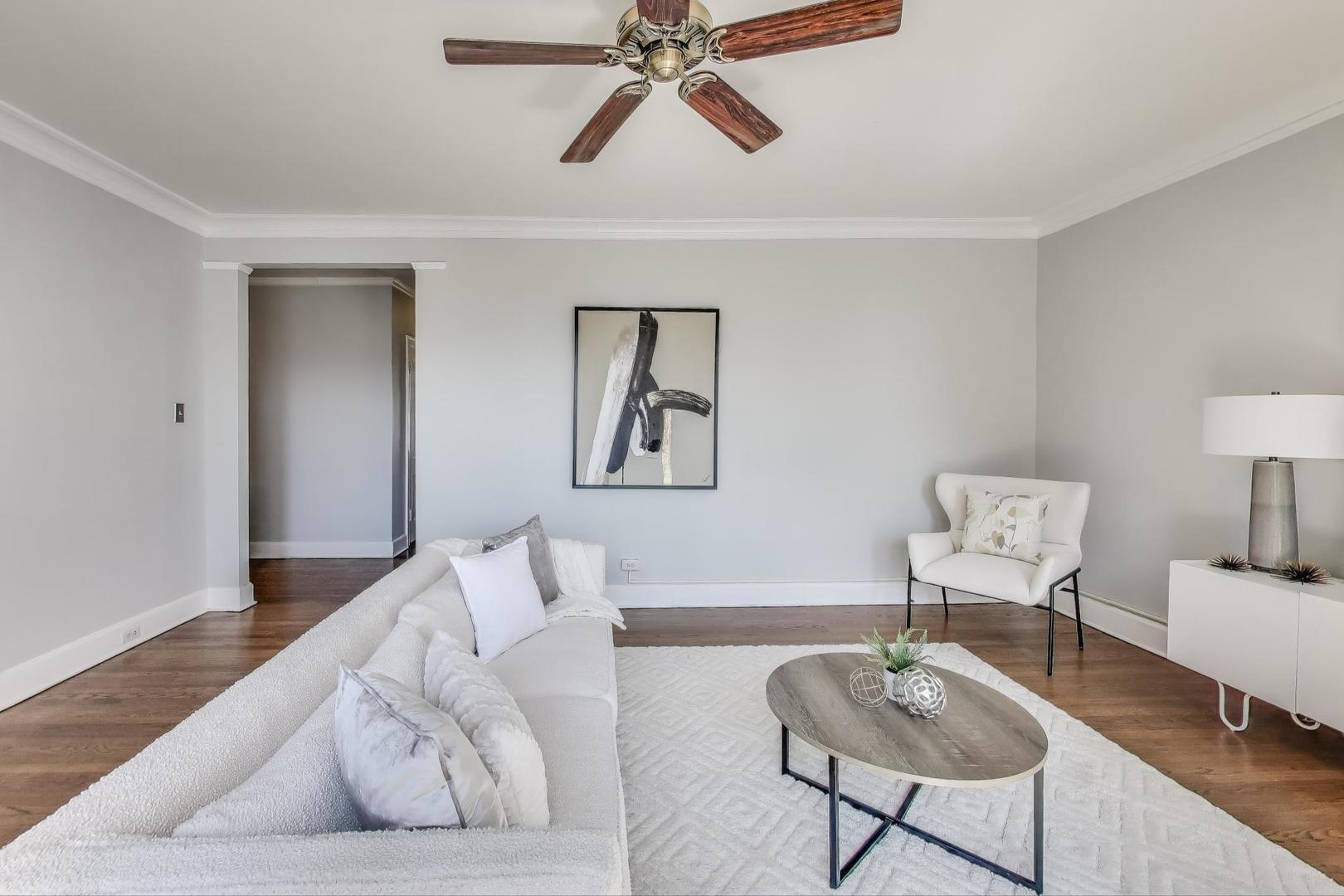 1755 East 55th Street, Unit 1204 Chicago, IL 60615 - Photo 6 of 19 a living room with furniture and a lamp