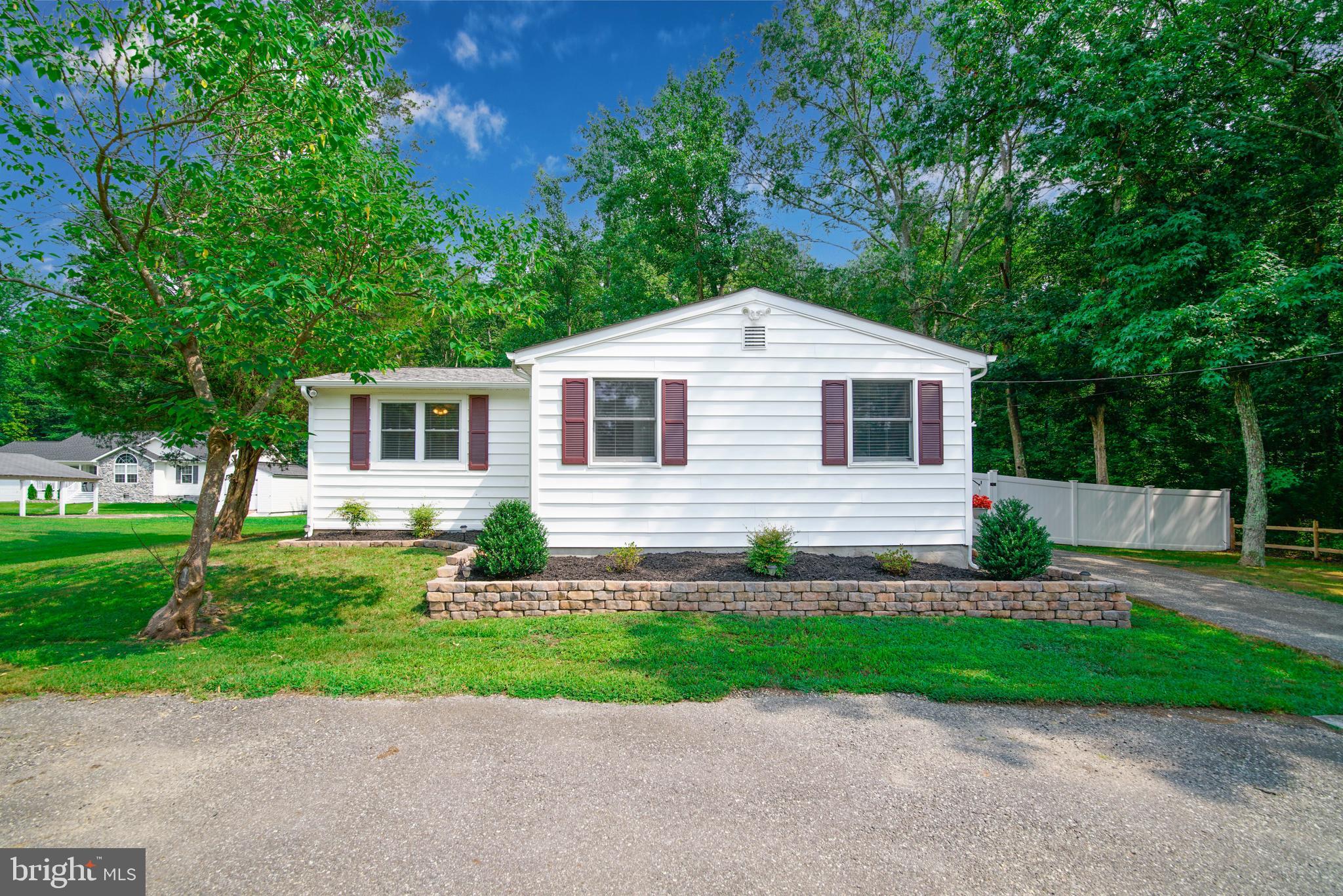 245 Newtown Road Solomons, MD 20688 - Photo 1 of 26 a front view of a house with a yard