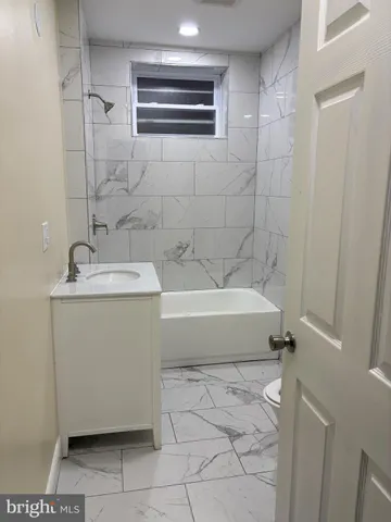a bathroom with a bathtub and shower