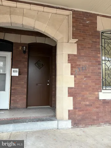 a brick building with a door and a window