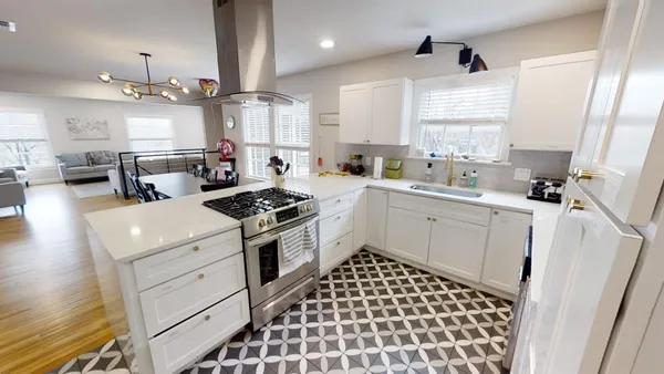a kitchen with a sink a stove a refrigerator and cabinets