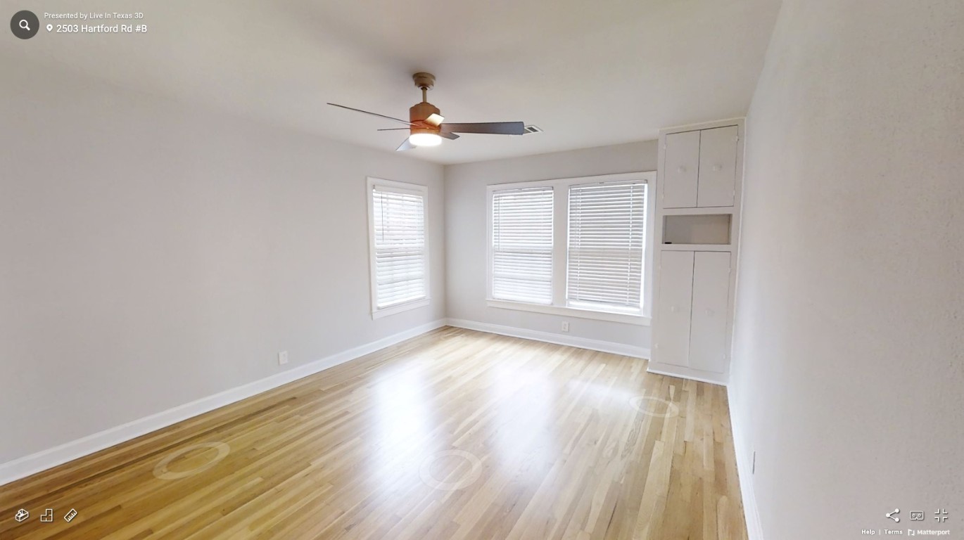 2503 Hartford Road, Unit B Austin, TX 78703 - Photo 8 of 14 Unfurnished room featuring light wood-style flooring and a ceiling fan