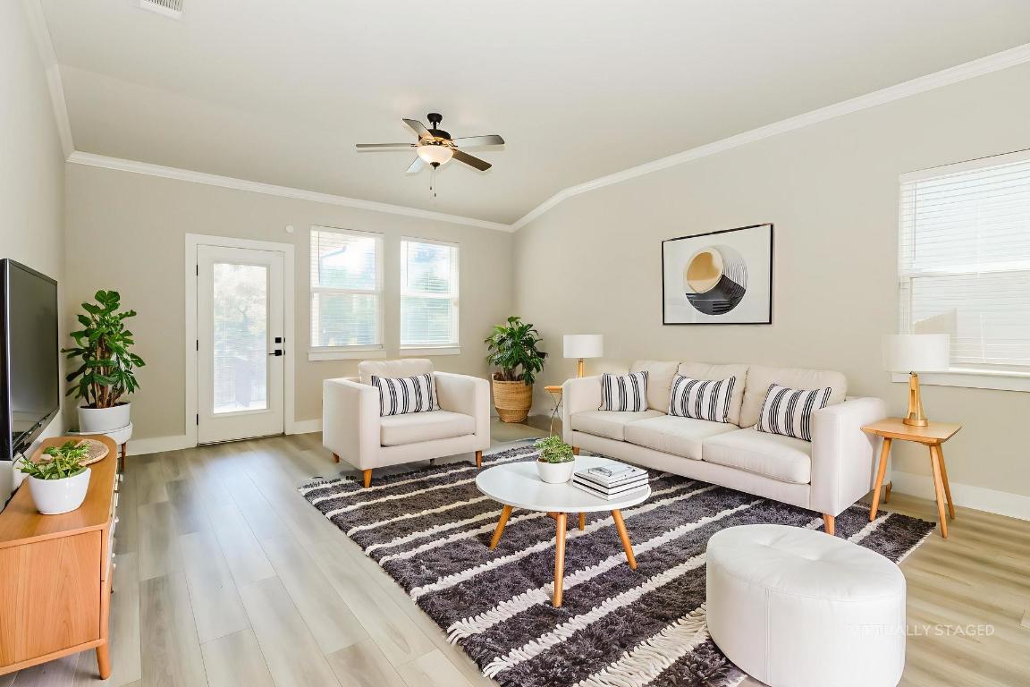 a living room with furniture and wooden floor