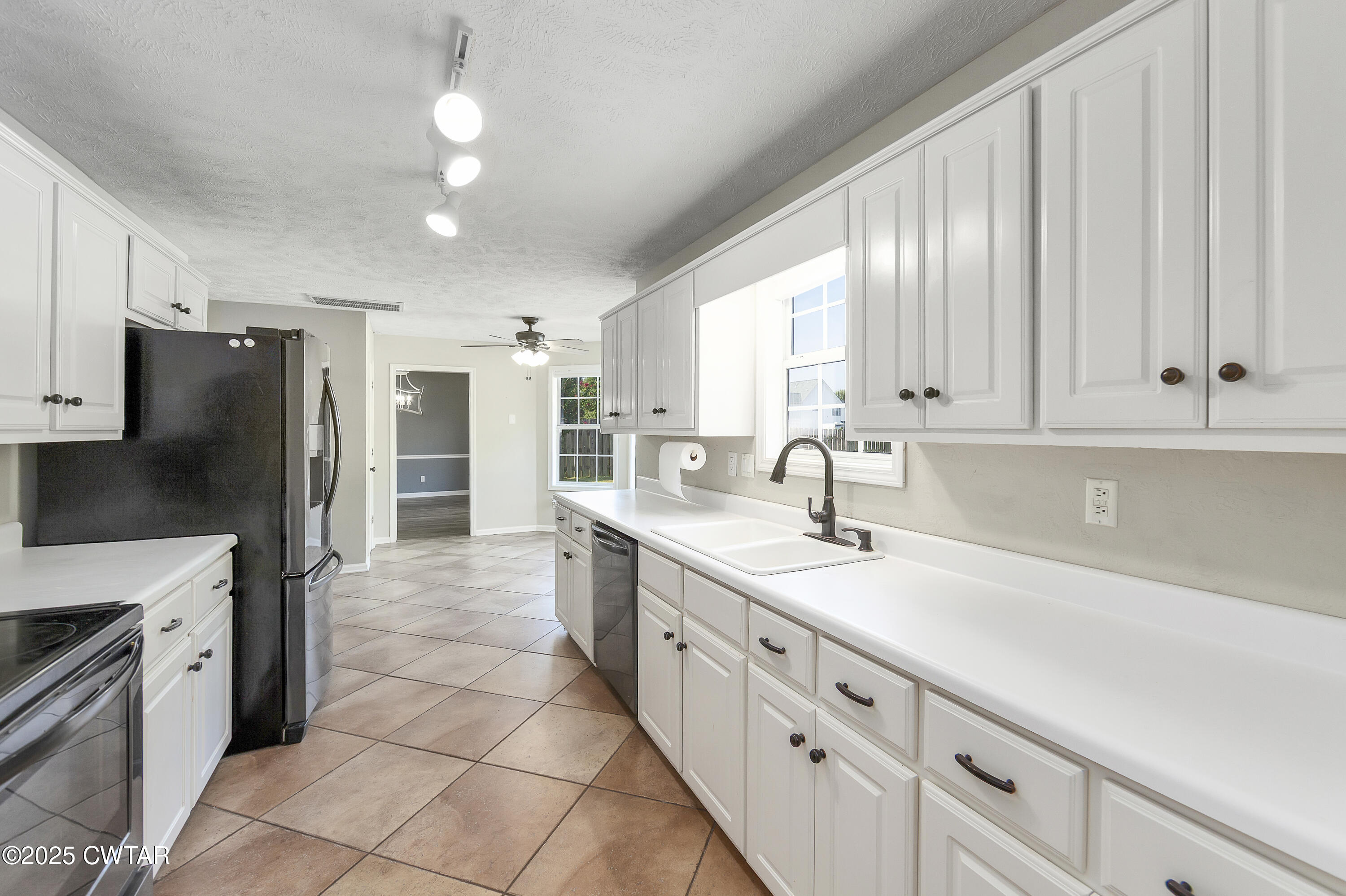 175 Willow Branch Drive Jackson, TN 38305 - Photo 15 of 39 a kitchen with granite countertop a sink stainless steel appliances and cabinets