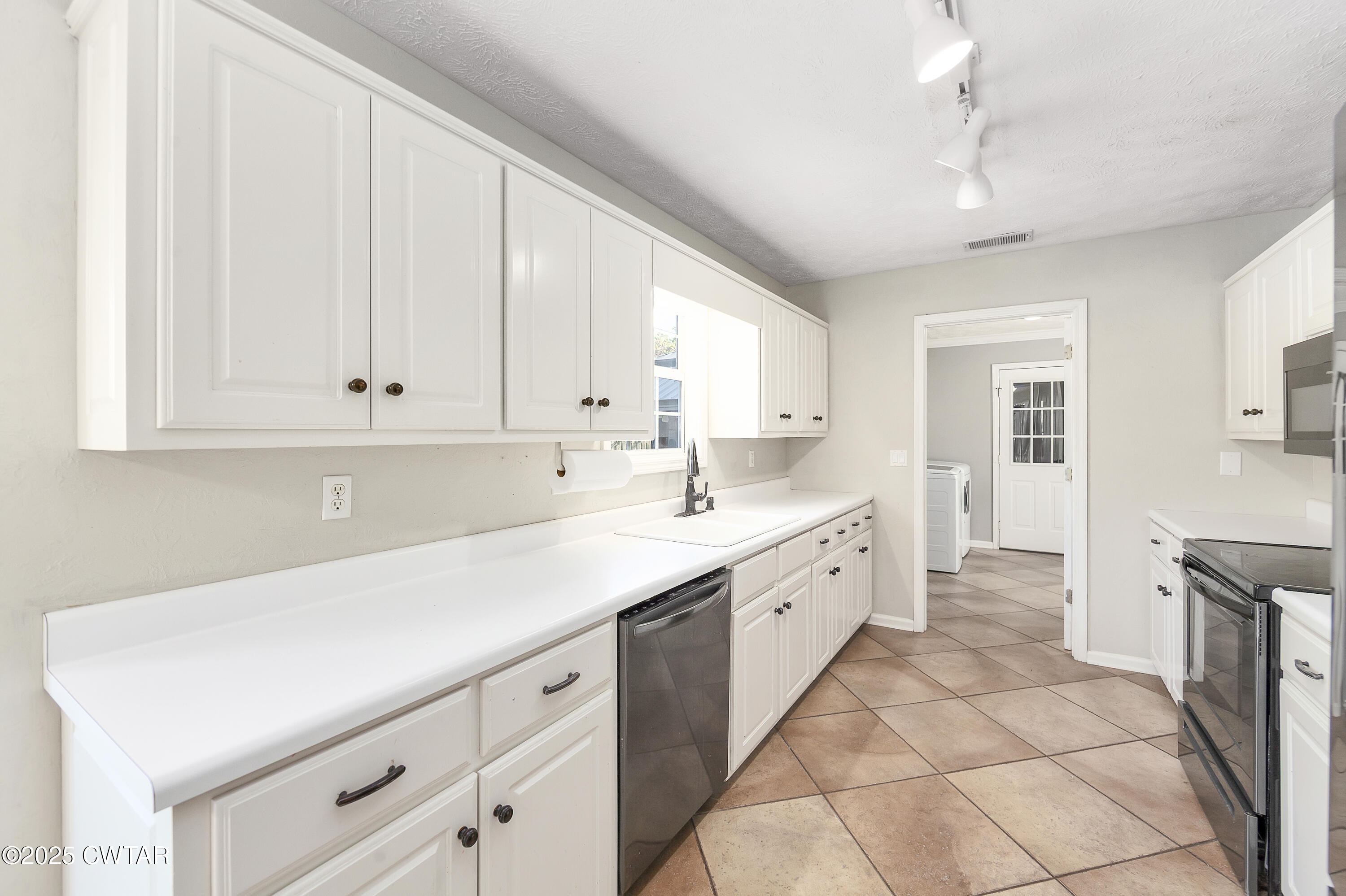175 Willow Branch Drive Jackson, TN 38305 - Photo 16 of 39 a kitchen with a sink cabinets and window