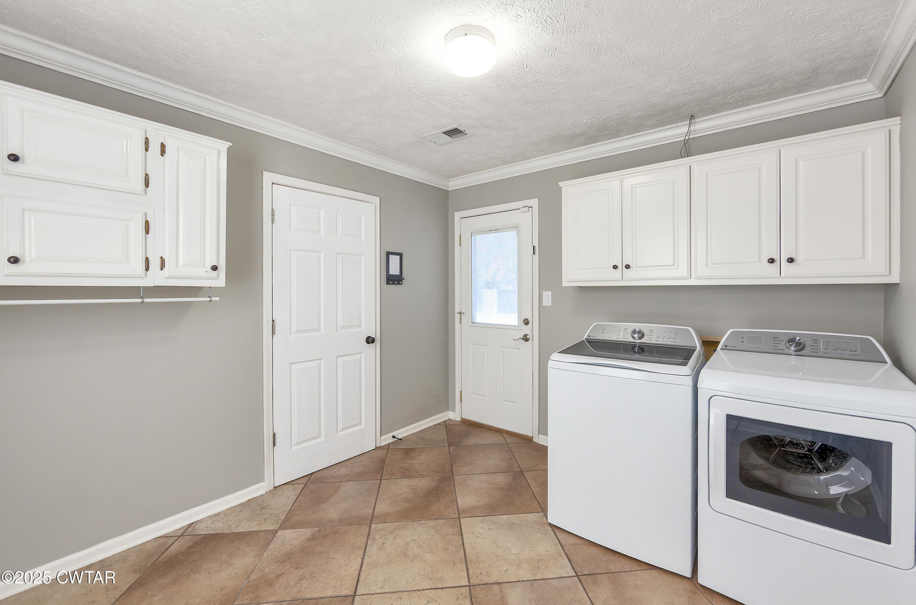 175 Willow Branch Drive Jackson, TN 38305 - Photo 17 of 39 a view of a storage and utility room with washer and dryer
