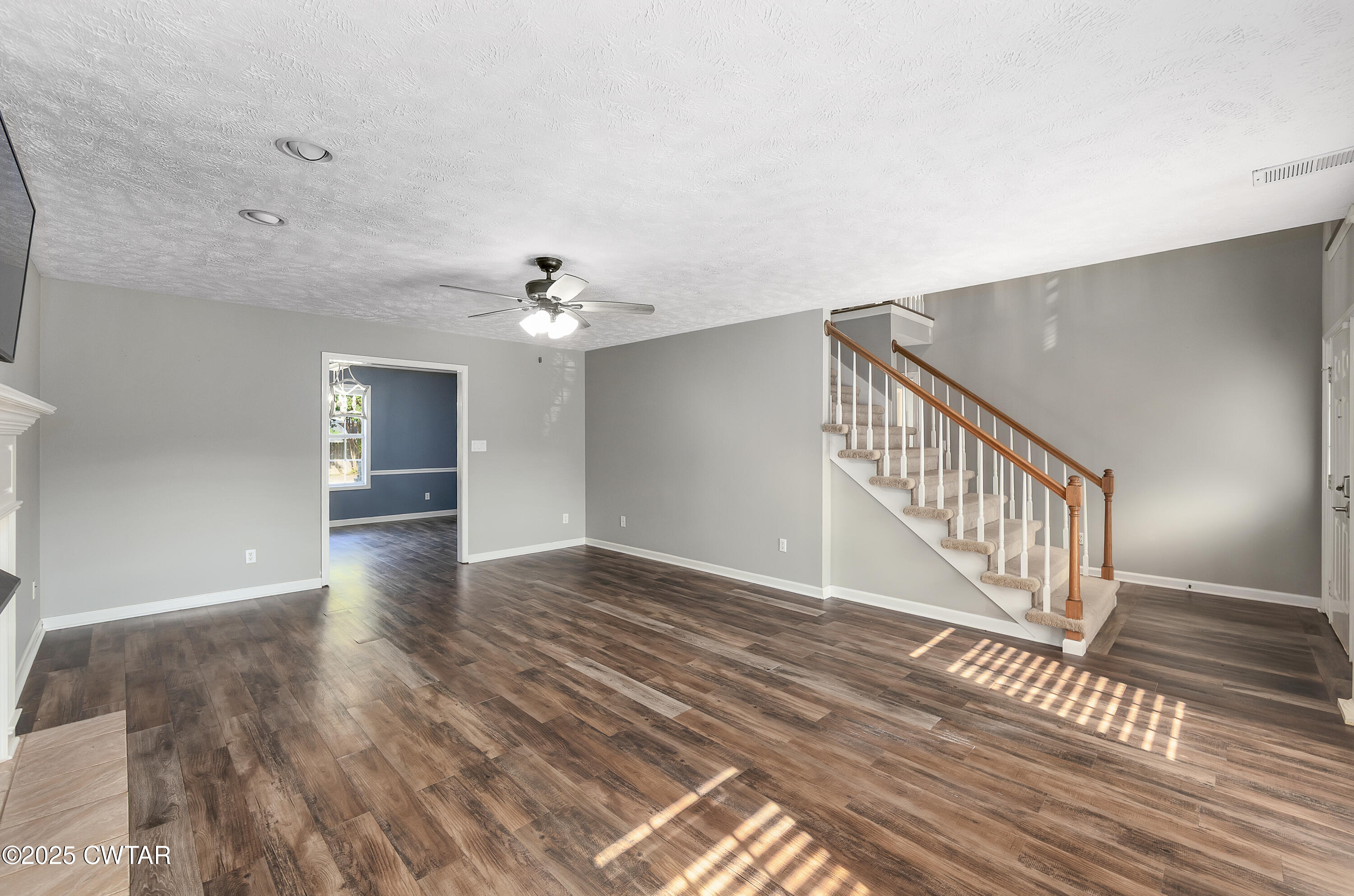 175 Willow Branch Drive Jackson, TN 38305 - Photo 7 of 39 a view of an empty room with wooden floor and a chandelier