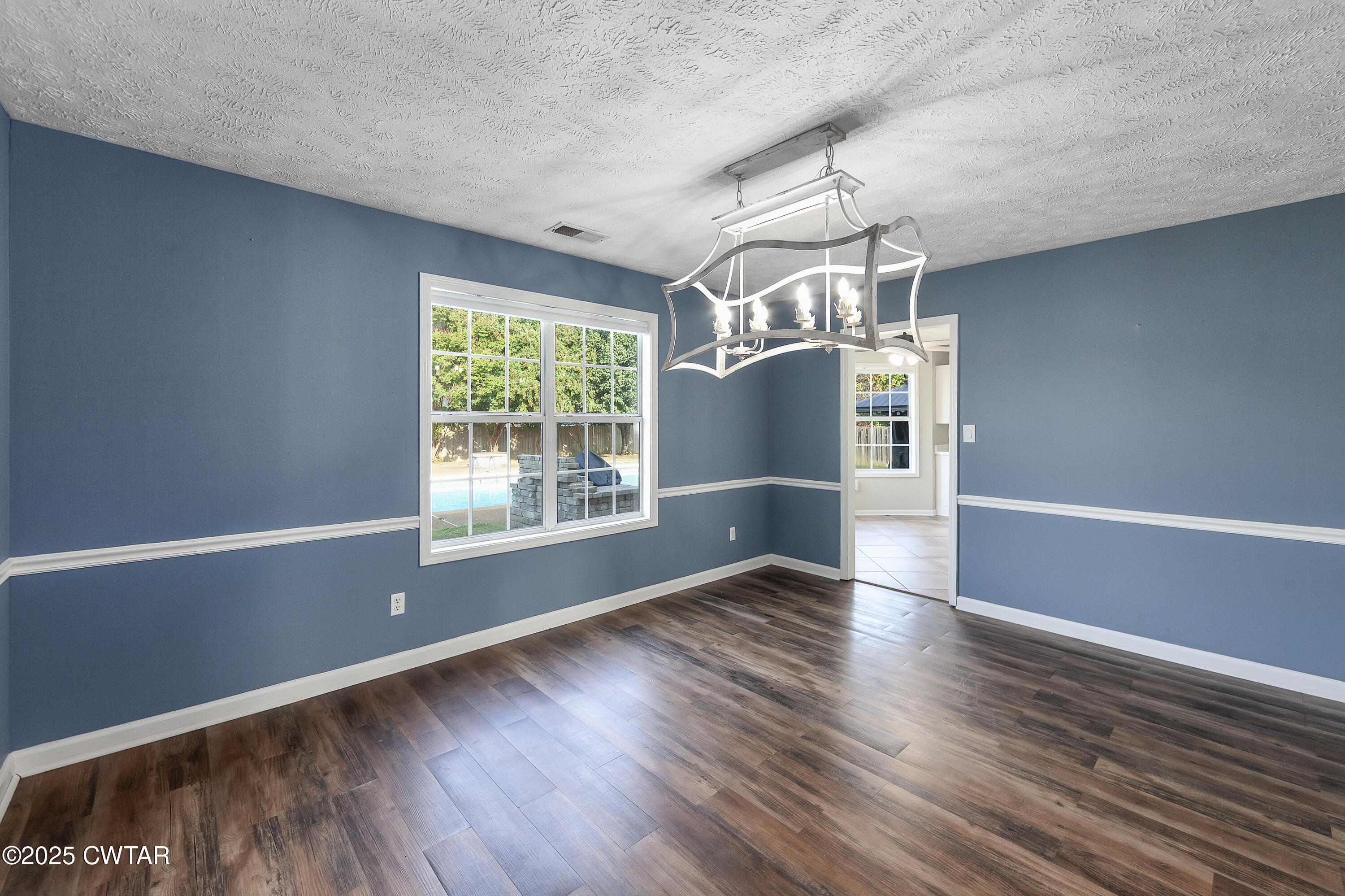 175 Willow Branch Drive Jackson, TN 38305 - Photo 9 of 39 a view of empty room with wooden floor and fan