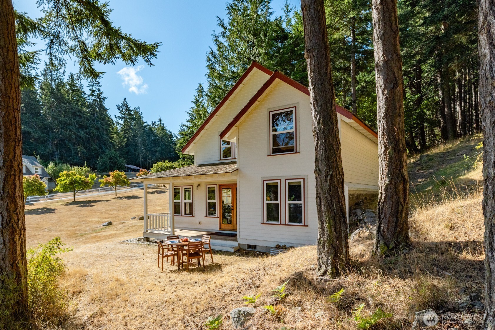 a view of a house with backyard and sitting area