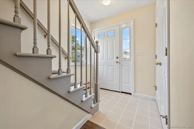 a view of entryway and hall with wooden floor