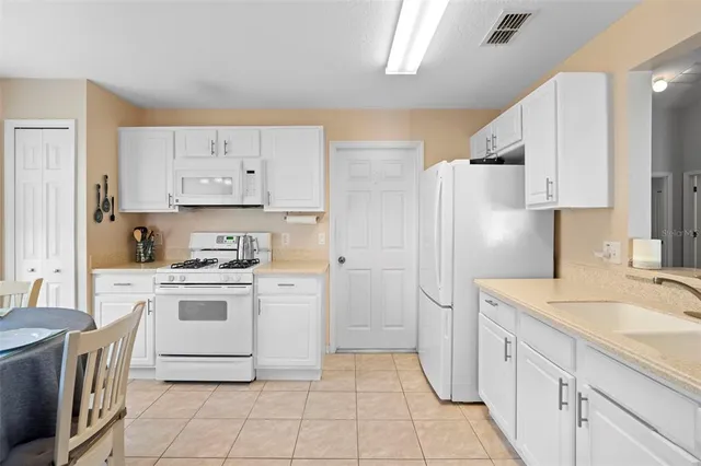 a kitchen with stainless steel appliances kitchen island granite countertop a sink and cabinets