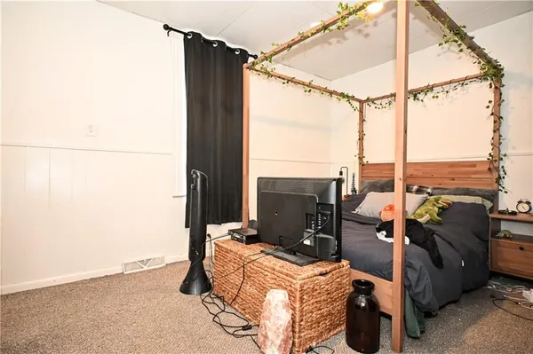 a bedroom with furniture and a window