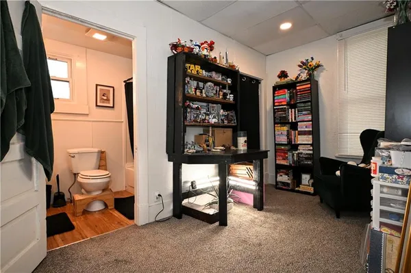 a bathroom with a toilet a sink and a window