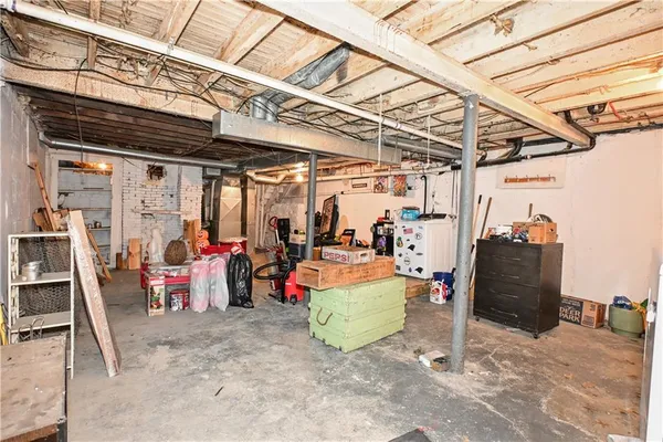 a bathroom with a refrigerator and a wooden floor