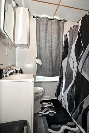 a bathroom with a granite countertop sink a toilet and a mirror