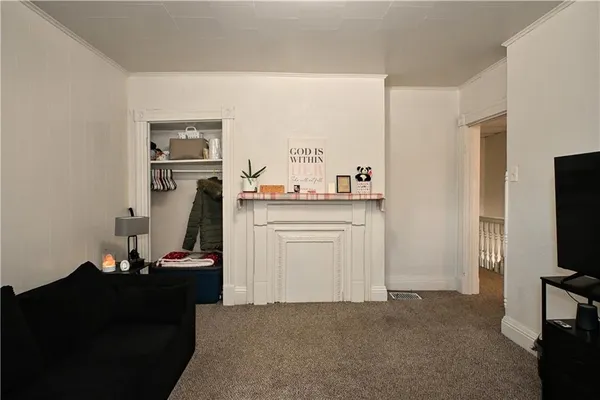 a view of a workspace with furniture and a flat screen tv