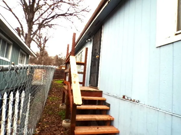 a view of balcony with wooden floor and fence