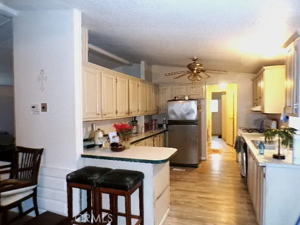 a kitchen with a refrigerator and a stove