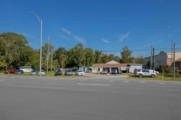 a view of the house with a cars park